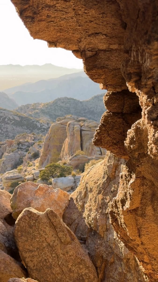 This may contain: rocks and boulders in the desert with mountains in the background