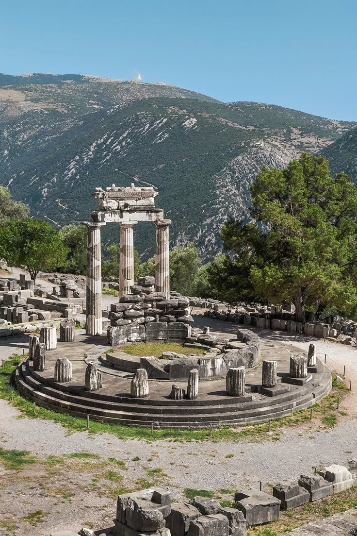 This may contain: an ancient roman city surrounded by mountains and trees