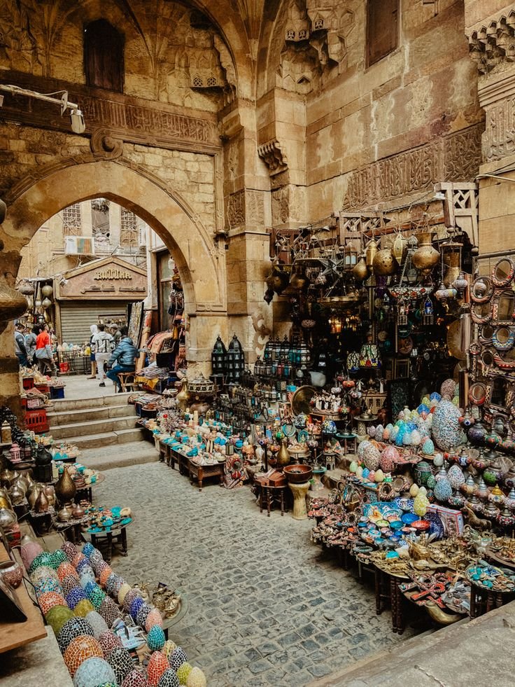 This may contain: an outdoor market with lots of items for sale in front of the entrance to it