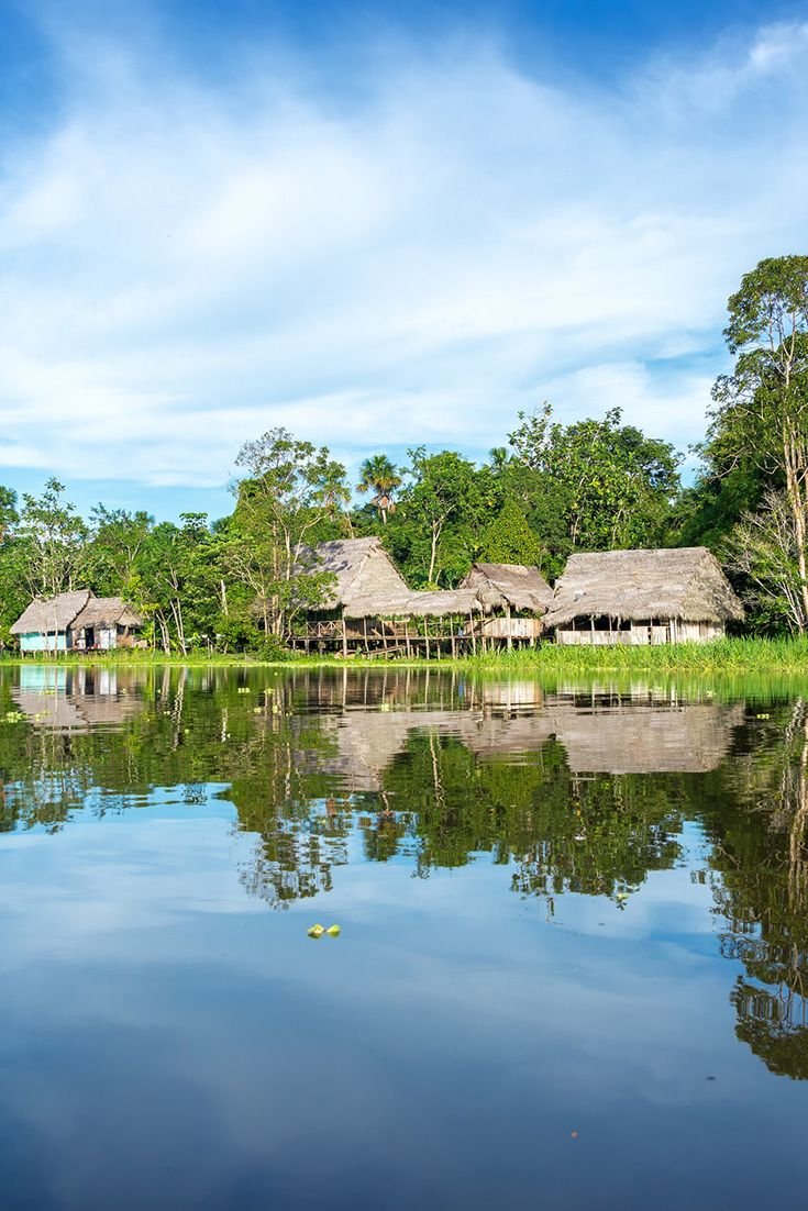 This may contain: an image of a lake with houses in the background