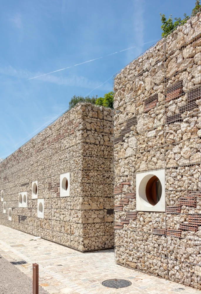 This may contain: a stone wall with holes in it and two walls made out of bricks on each side