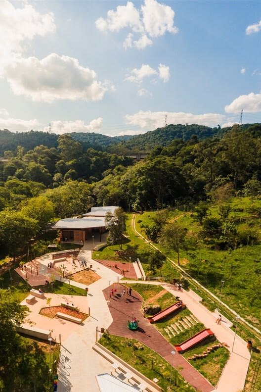 This may contain: an aerial view of a skate park in the middle of a green field with trees