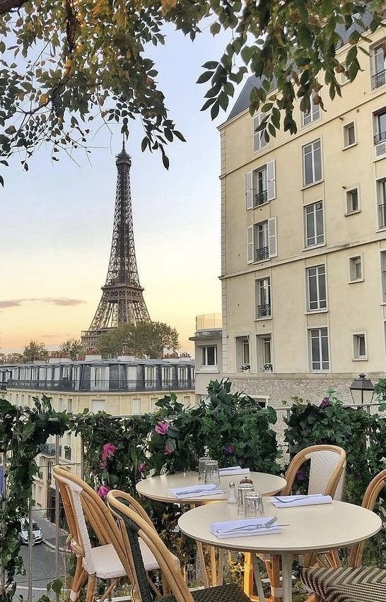 This may contain: tables and chairs with the eiffel tower in the background