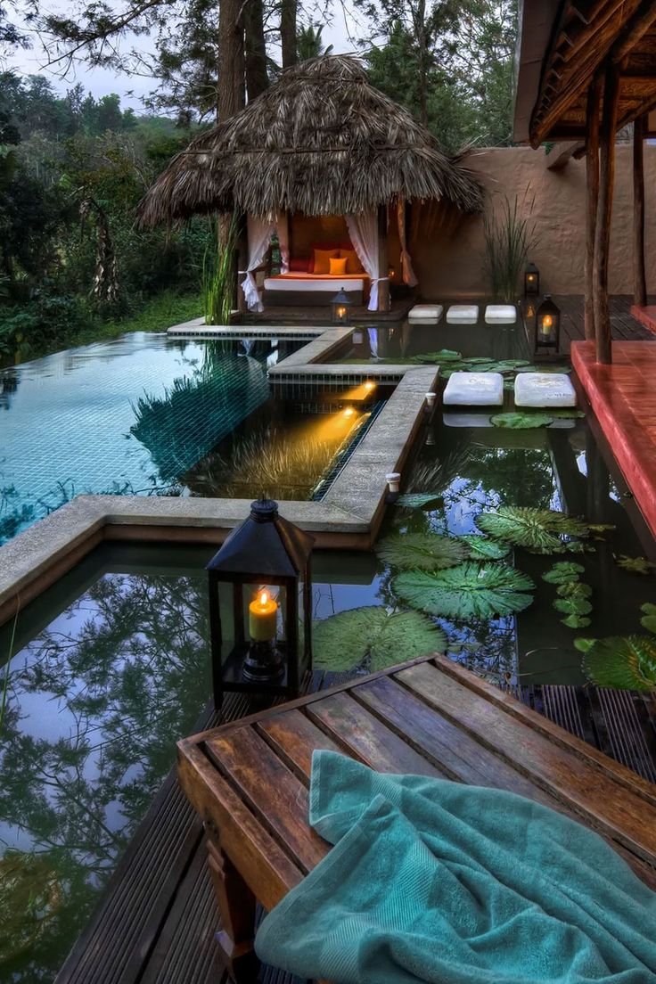 This may contain: an outdoor pool with a gazebo next to it and some lights on the side