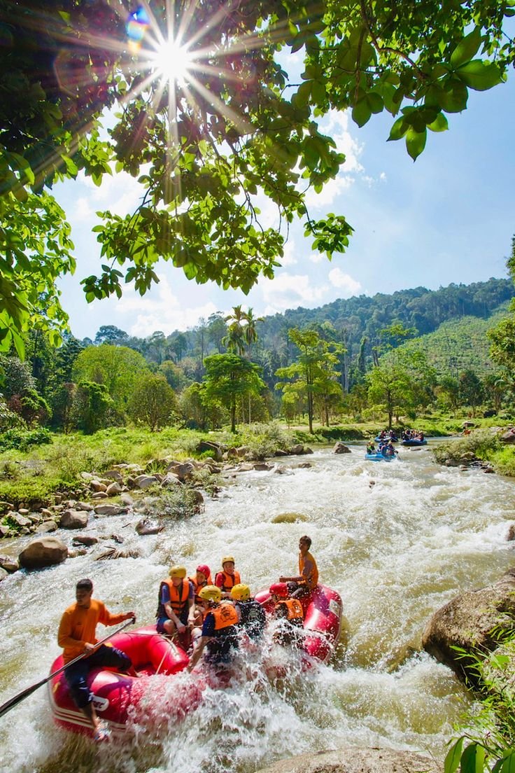 This may contain: a group of people riding rafts down a river