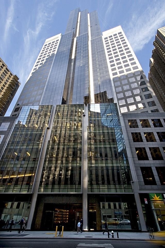 This may contain: the tall buildings are all glass and have many windows