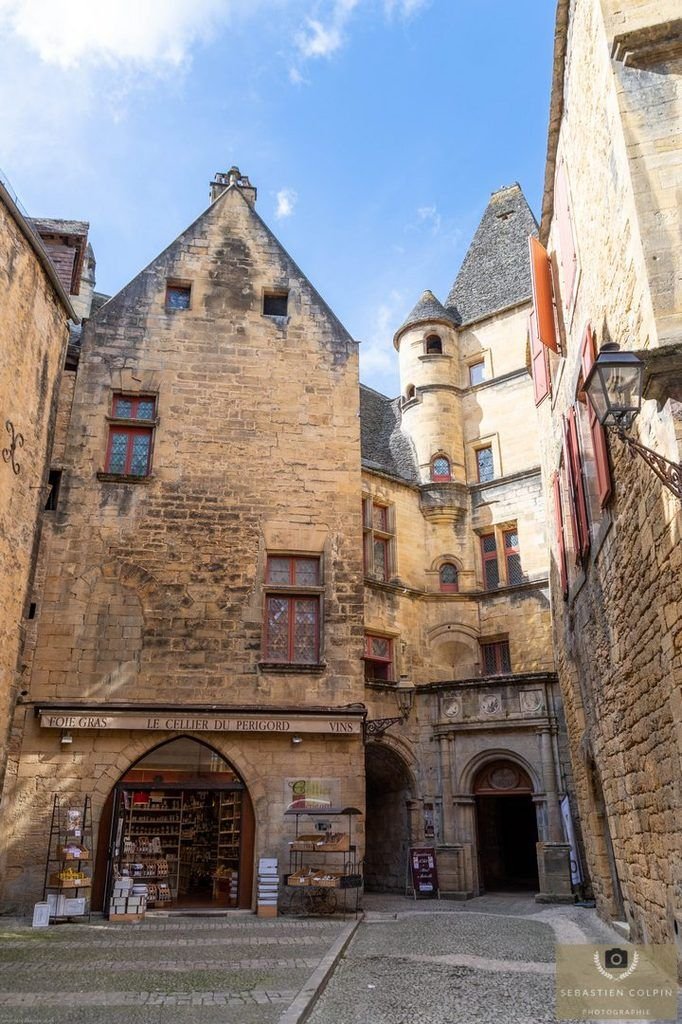 This may contain: an old stone building with lots of windows on it's sides and some stairs leading up to the entrance