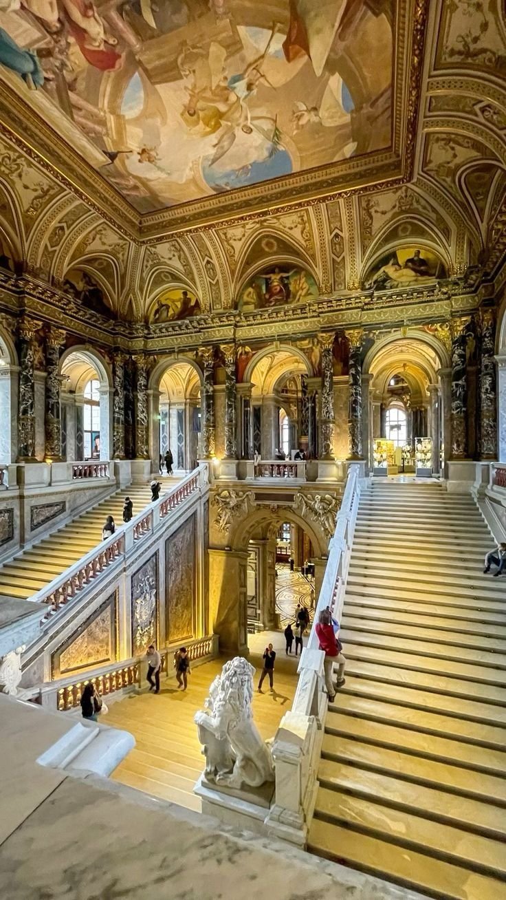 This may contain: an ornate building with stairs and paintings on the ceiling