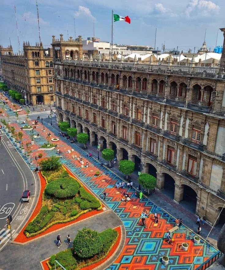 This may contain: an aerial view of the plaza in front of a large building with colorful tiles on it