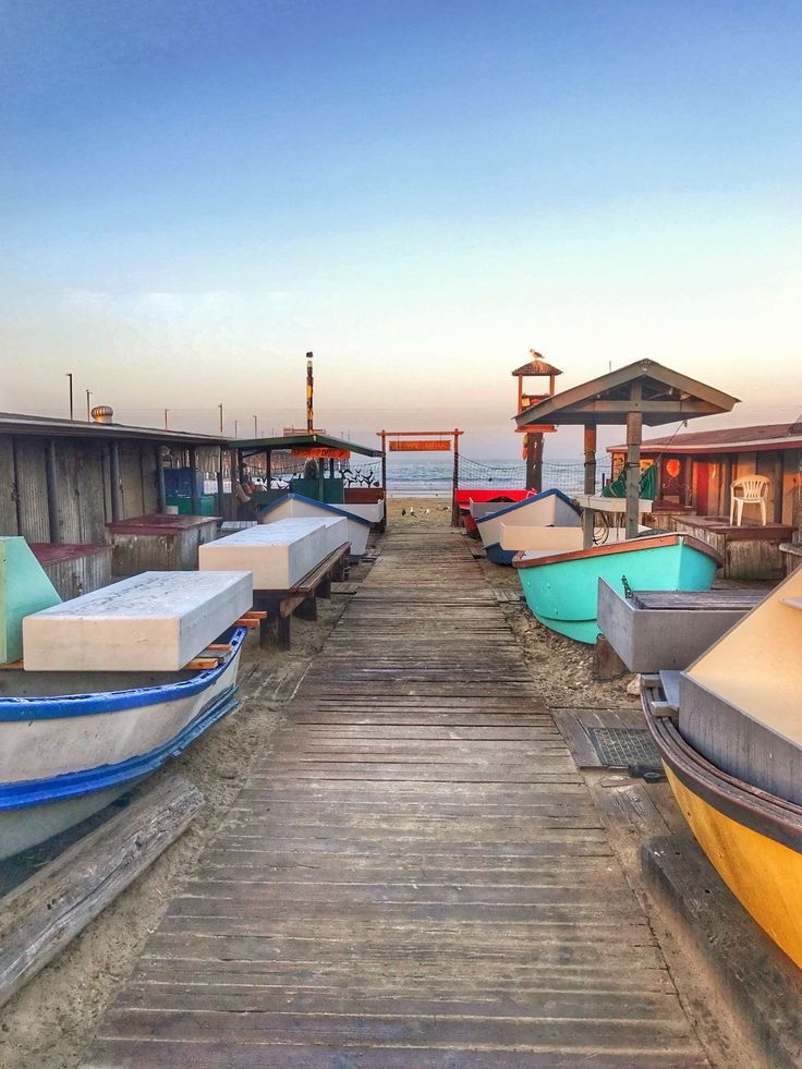This may contain: there are many small boats on the dock