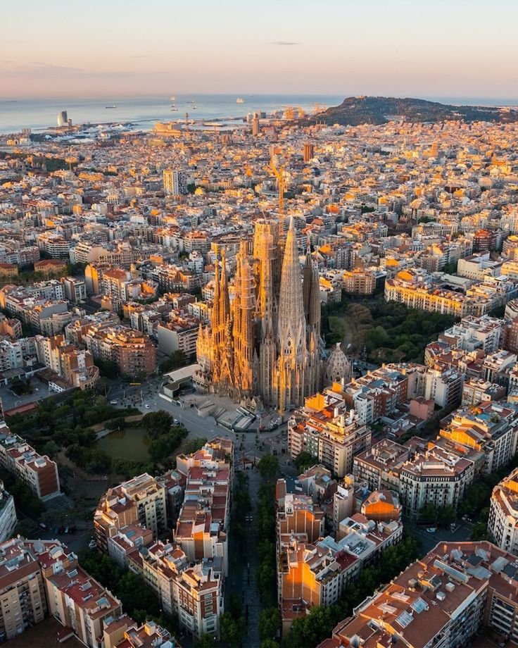 This may contain: an aerial view of barcelona, spain with the cathedral in the foreground and surrounding buildings