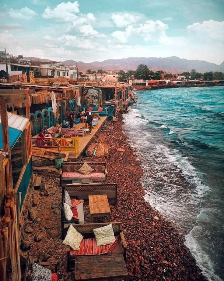 This may contain: the beach is lined with old wooden benches