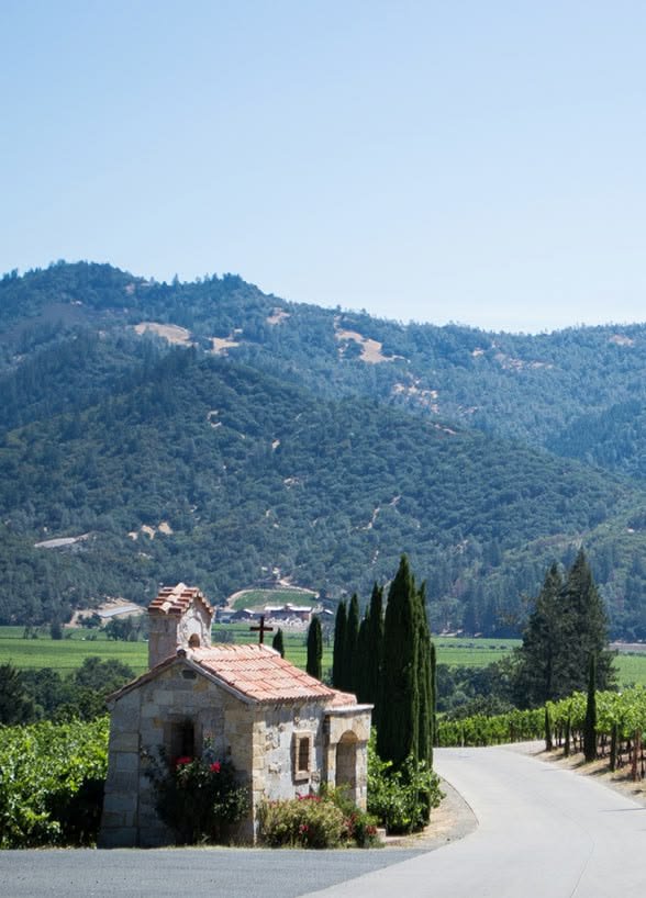 This may contain: an old stone house with the words budget travel tips for napa valley on it