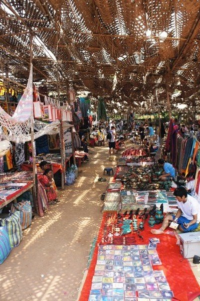 This may contain: an outdoor market with lots of items for sale