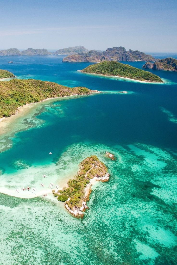 This may contain: an aerial view of several small islands in the ocean