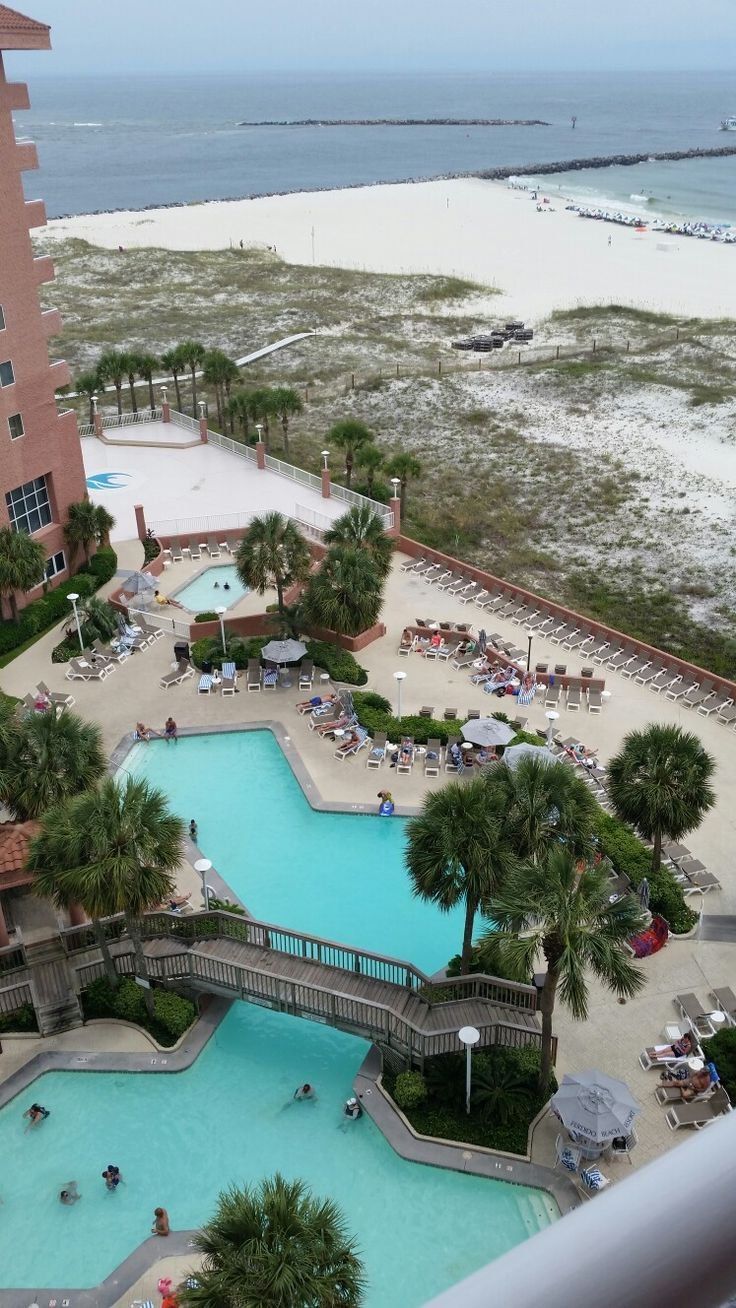 This may contain: an aerial view of the pool and beach from a room at the hilton oceanfront resort