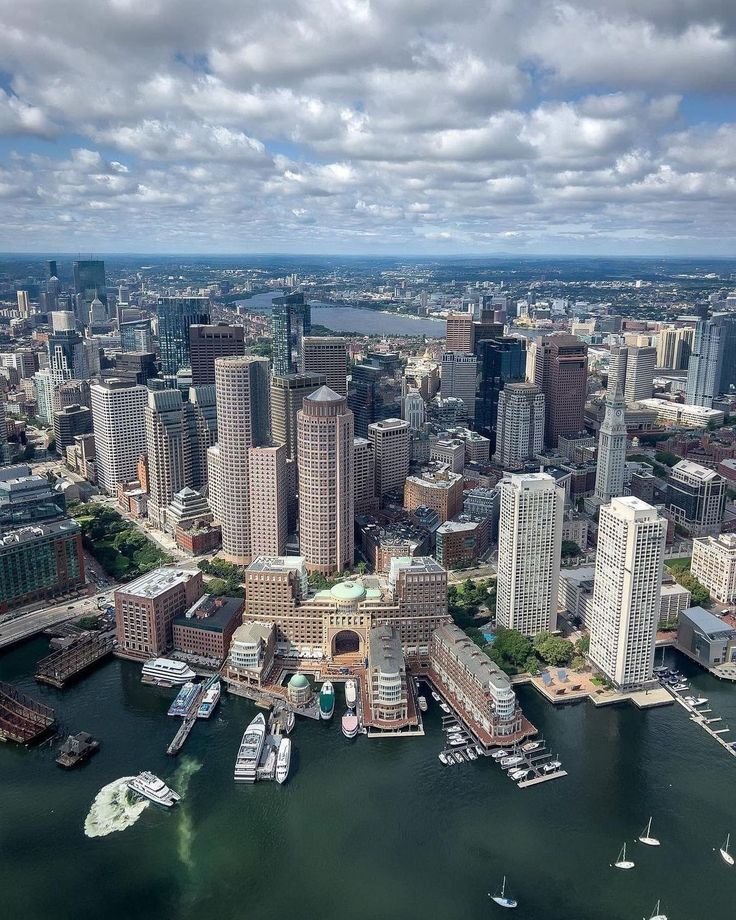 This may contain: an aerial view of a city with boats in the water