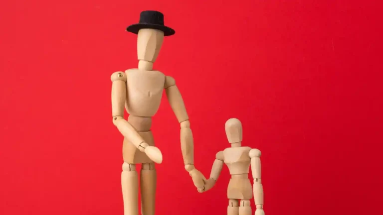 Wooden mannequin with a smaller wooden child, representing National Short Person Day