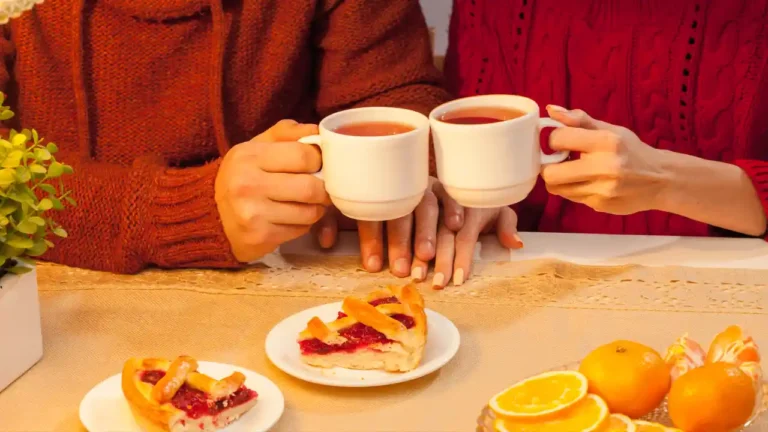 Happy young couple enjoying tea for National Afternoon Tea Day.