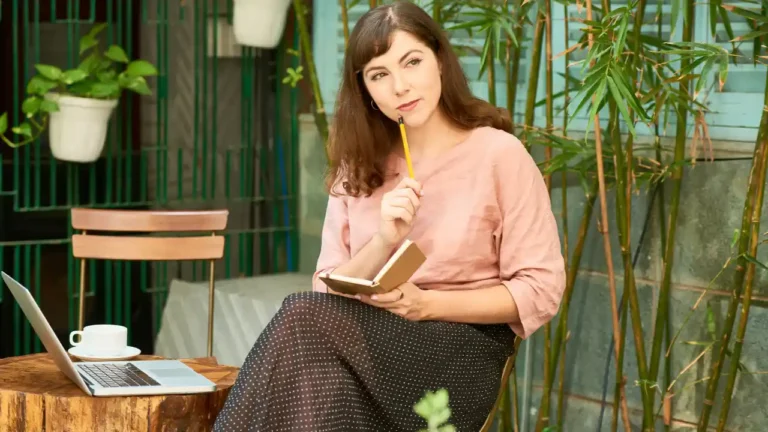 Pensive woman with notepad for National Encourage a Young Writer Day