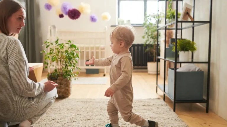 Little boy making his first steps for National First Foot Day