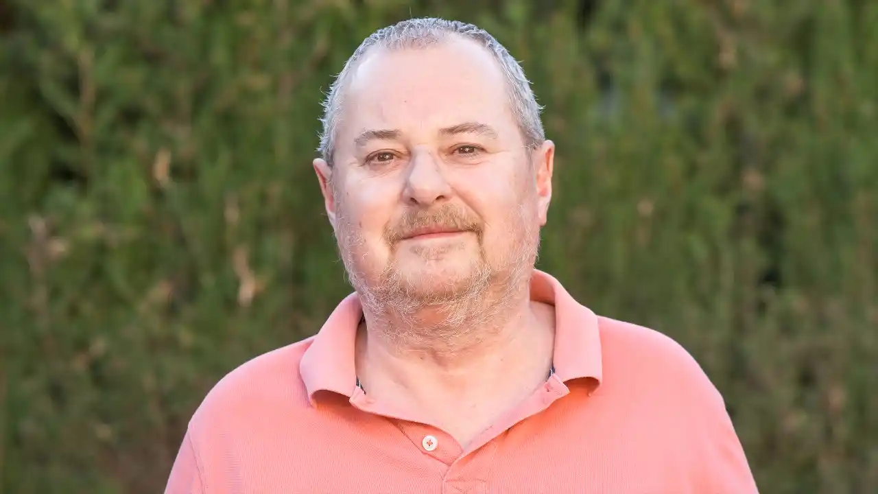 Positive bearded man standing in the countryside for National Robert Day.