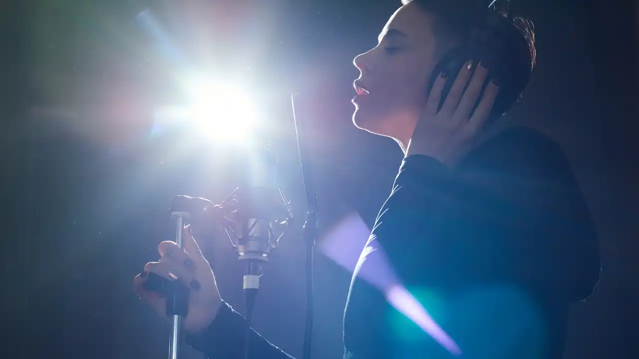 Stylish singer in a recording studio celebrating National Taylor Day