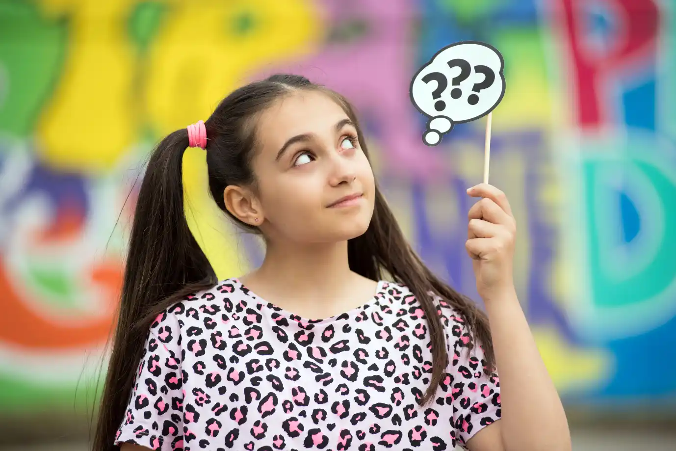 Girl holding up question mark for National Trivia Day