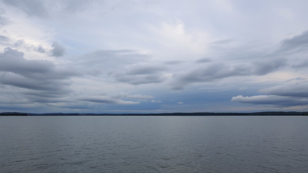 A serene landscape of grey clouds over a tranquil lake