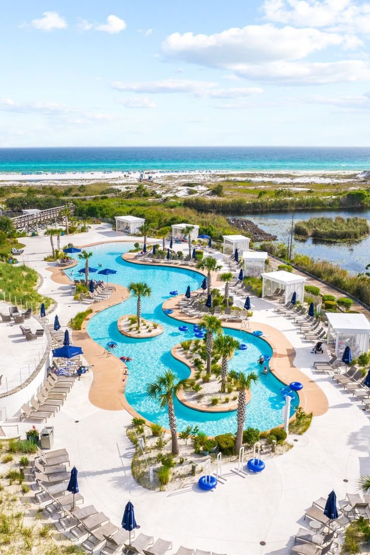 This may contain: an aerial view of the pool and beach area at seagate resort in destinia, florida