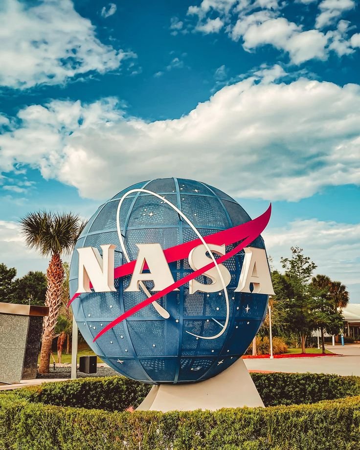 This may contain: the nasa sign in front of a palm tree