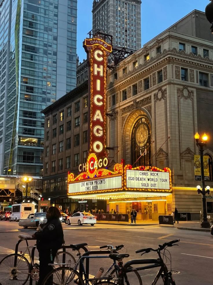 This may contain: the chicago theater marquee is lit up at night