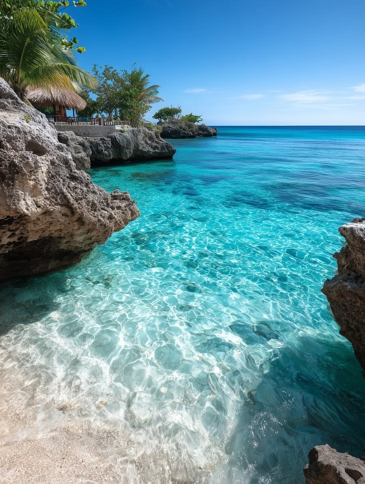 This may contain: the water is crystal blue and clear