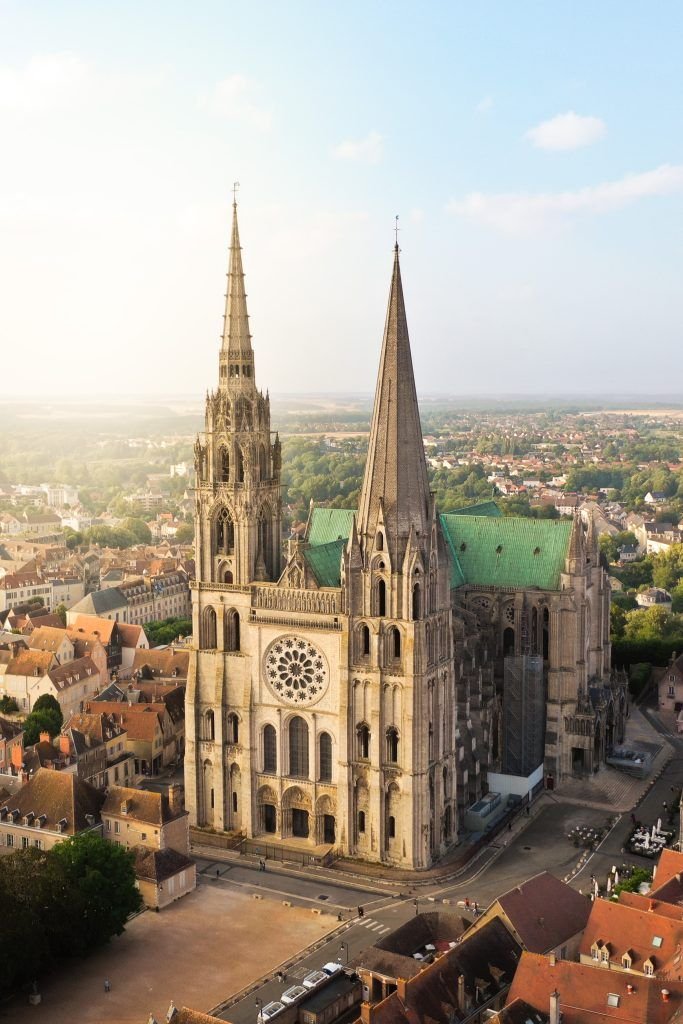 This may contain: an aerial view of a large cathedral in the middle of a city with tall spires