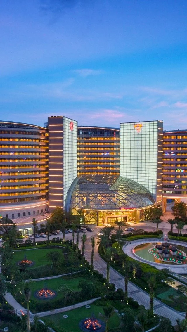 This may contain: an aerial view of the hotel and casino at dusk, with lights on in the foreground