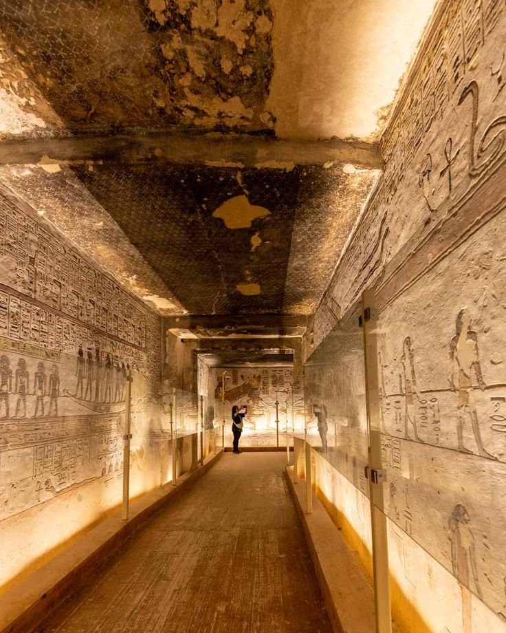 This may contain: a long hallway with paintings on the walls and ceiling in an ancient egyptian style building