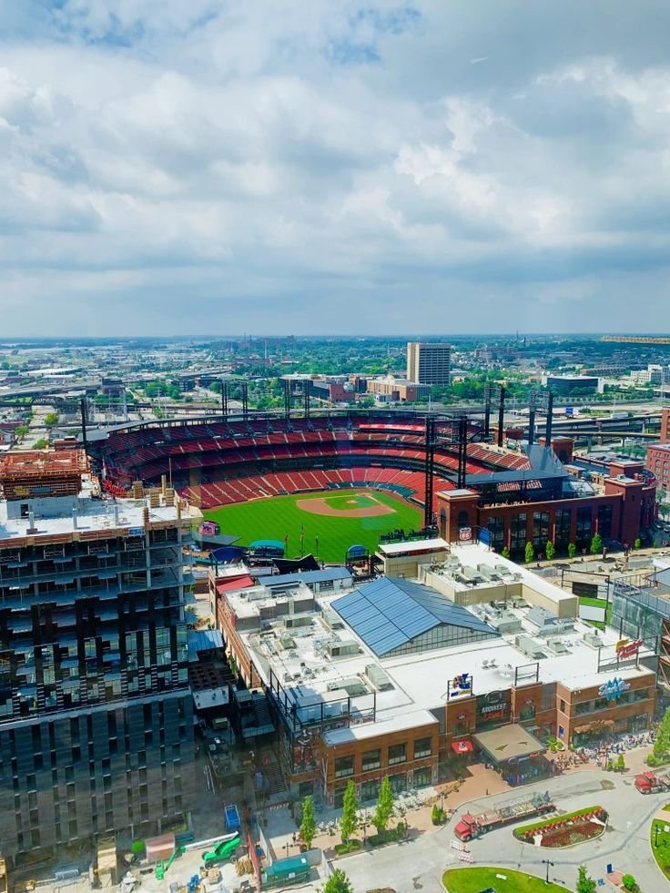 This may contain: an aerial view of a baseball stadium and surrounding buildings