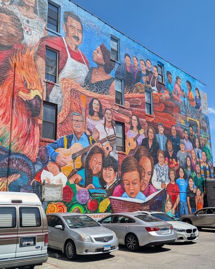 This may contain: a large mural on the side of a building with many different people painted on it