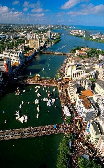 This may contain: an aerial view of a city with boats in the water