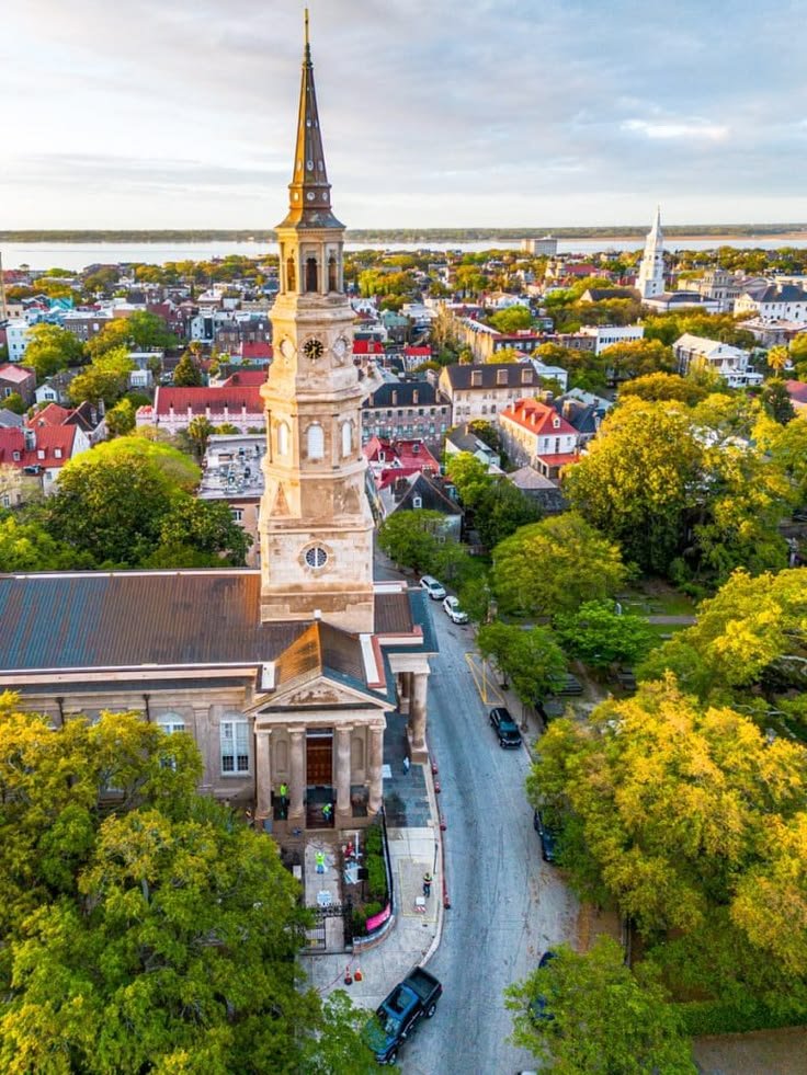 This may contain: an aerial view of a church in the middle of a city with trees and buildings