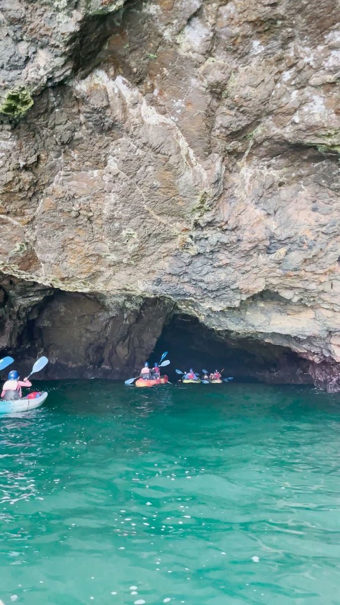 This may contain: several people are kayaking in the blue water