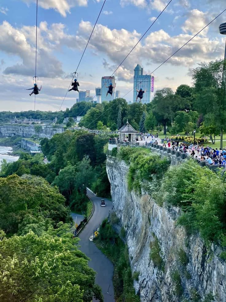 This may contain: people are riding on the cable cars above the city