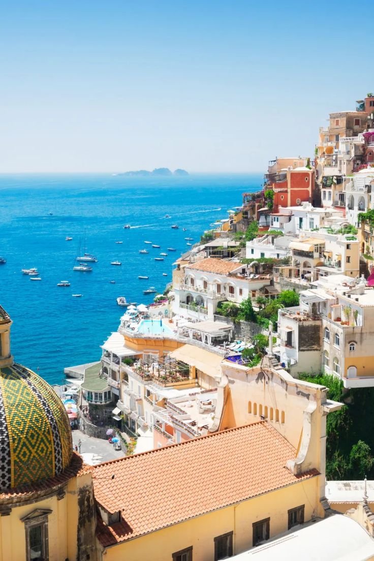 This contains: This pin showcases top November honeymoon destinations, perfect for couples seeking ideal weather and beautiful scenery. Discover stunning tropical locations and winter wonderlands for an unforgettable romantic getaway. The pin features one captivating image of Italy's Amalfi Coast.