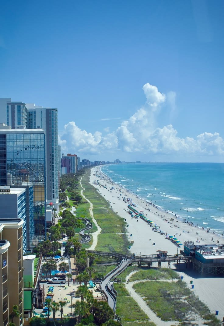 This may contain: an aerial view of the beach and ocean in miami, florida with high rise buildings