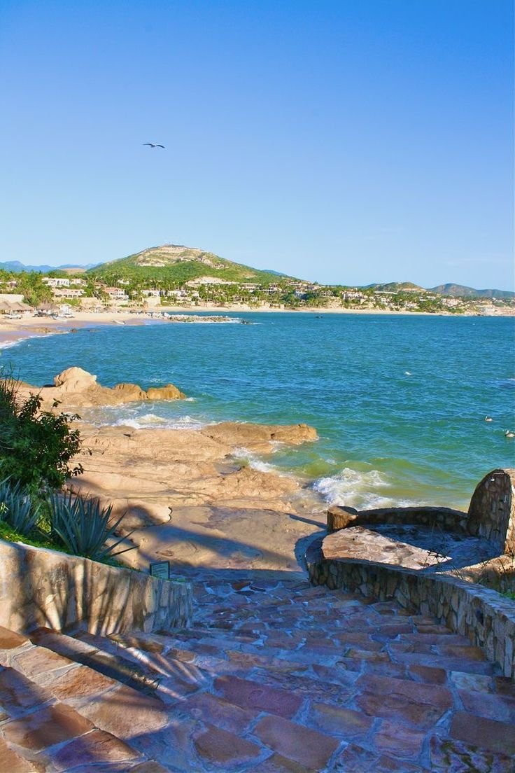 This may contain: the steps lead down to the beach from the water's edge, leading into the ocean
