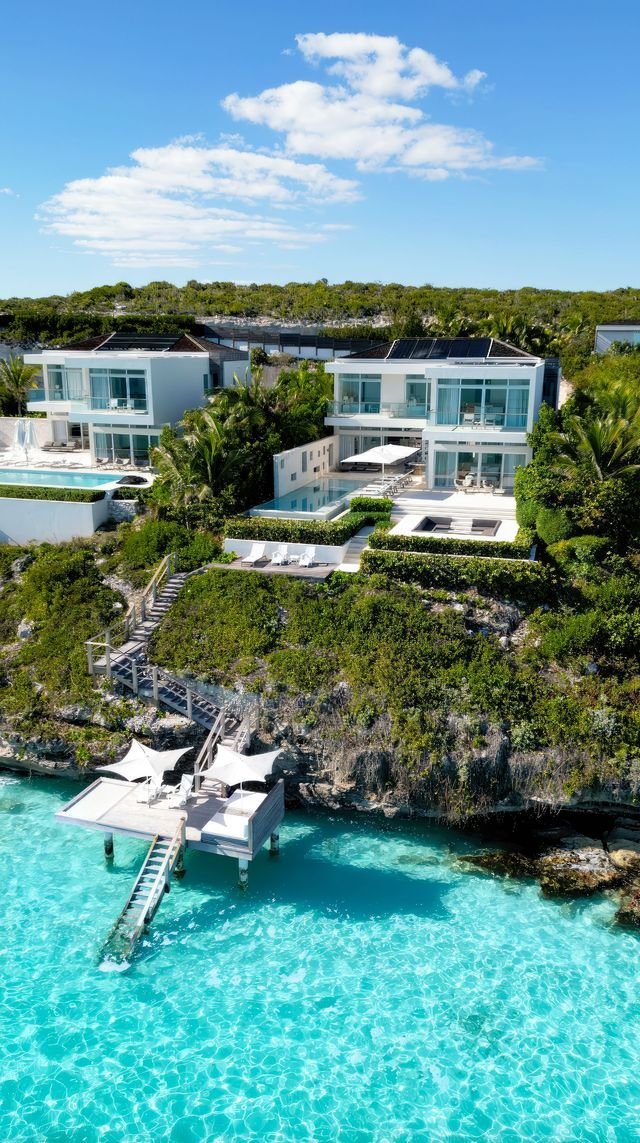 This may contain: an aerial view of a house on the water