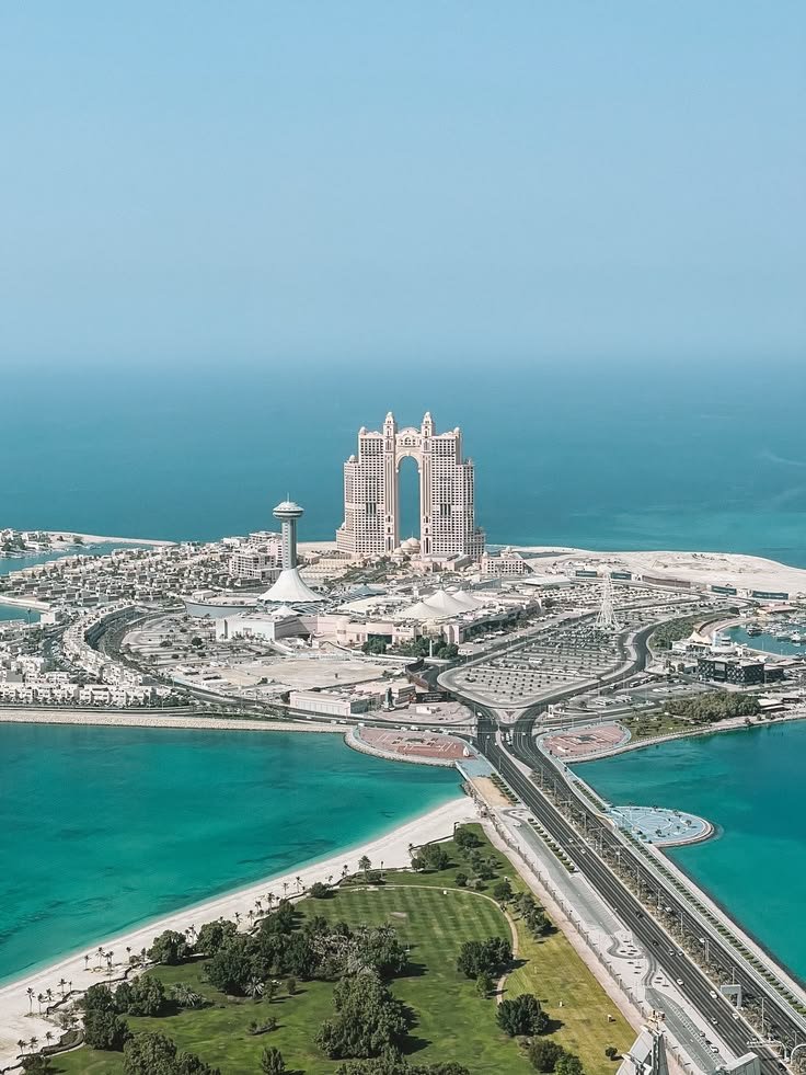 This may contain: an aerial view of the city and its surrounding coastline in abu, united arab emirates