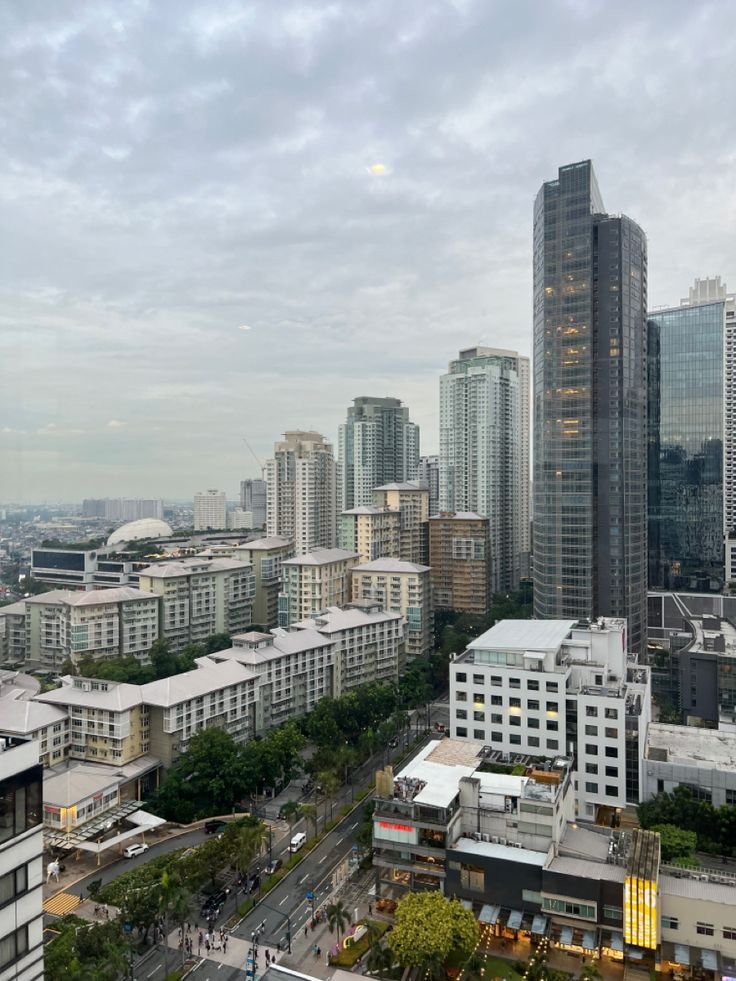 This may contain: the city is full of tall buildings and skyscrapers