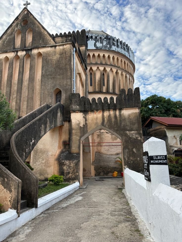 This may contain: an old building with stairs leading up to it