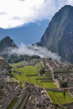 This may contain: an aerial view of the ancient city of machalucca, with mountains in the background